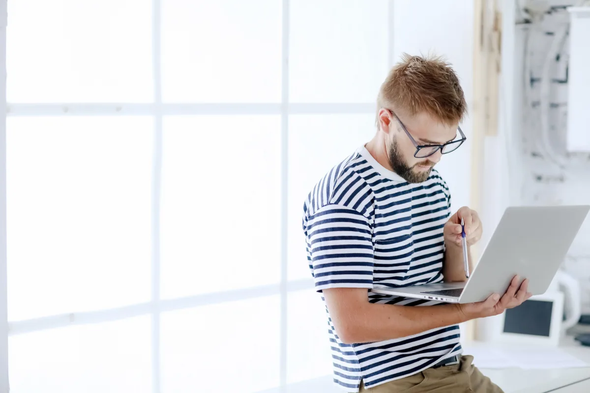 A small-business founder reviewing their newly launched website on a laptop, planning content that AI search tools can cite