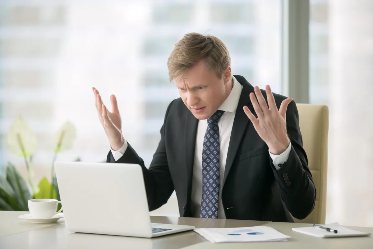 Puzzled business owner at his laptop wondering why his website isn't on Google
