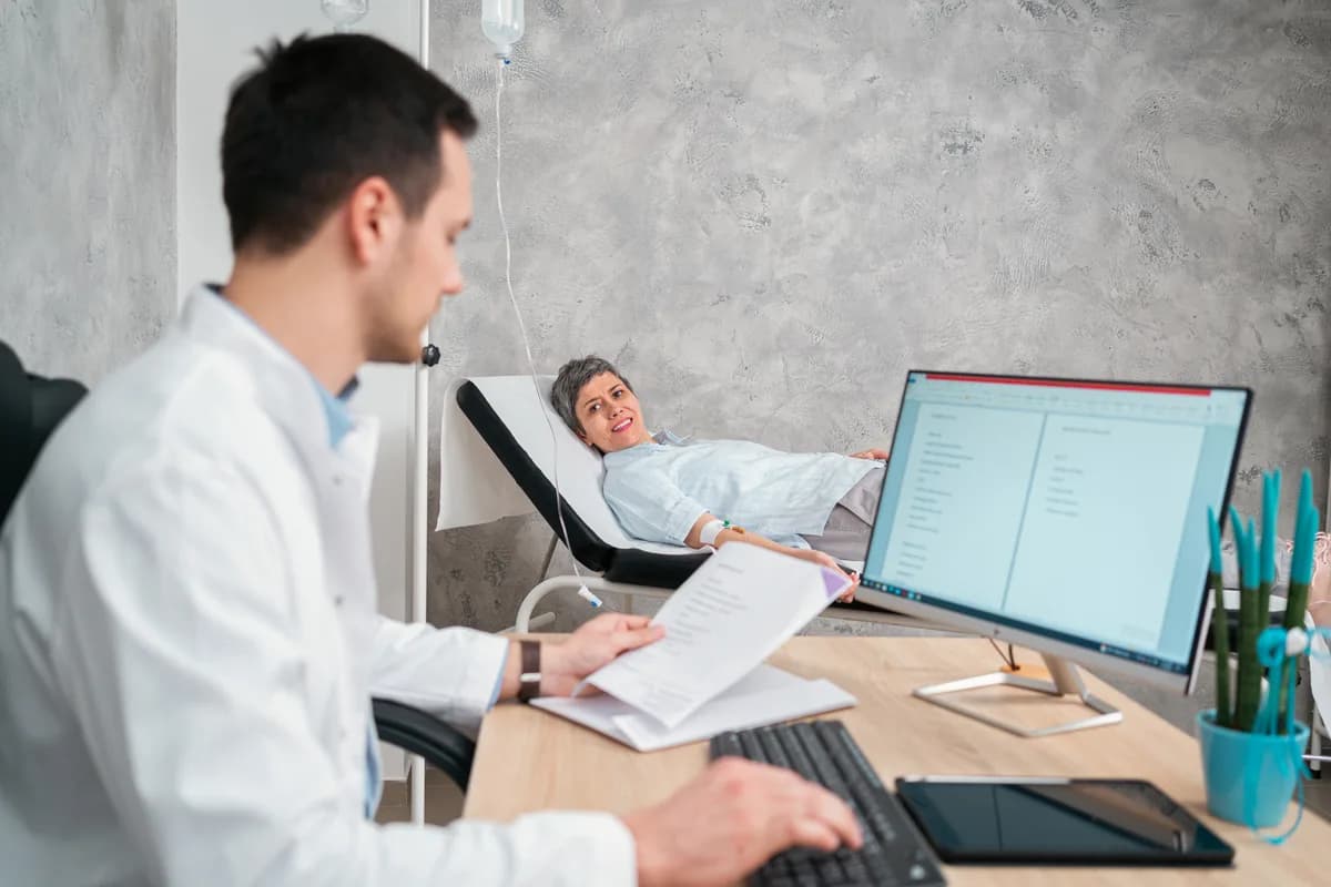 A sleep medicine physician reviewing a patient's sleep study results during a consultation