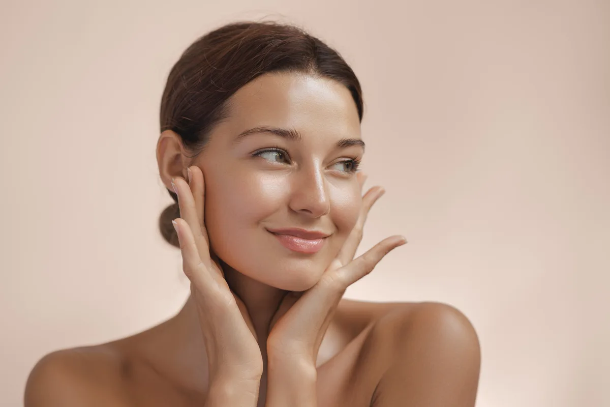 A calm portrait of glowing, well-cared-for skin in soft natural light