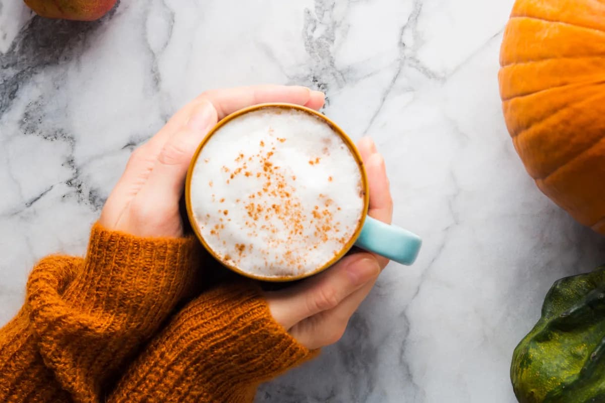 Hands holding a warm mug of coffee