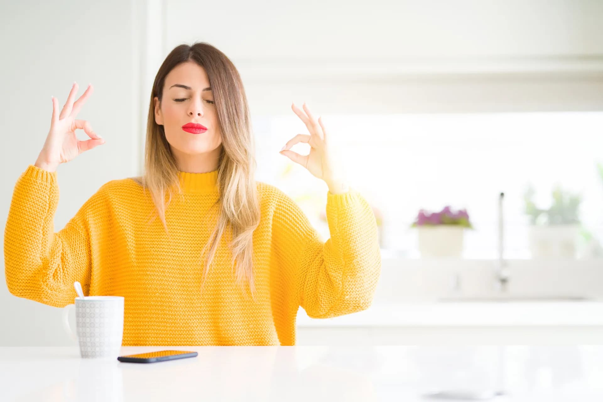 A young woman with coffee in a peaceful posture at home