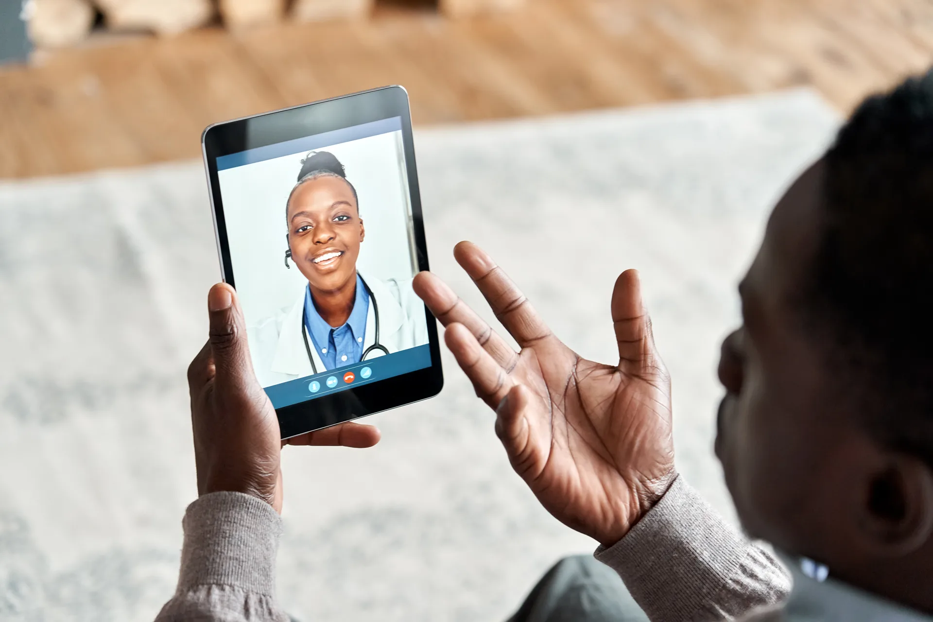 A patient holding their place in line on a tablet from home