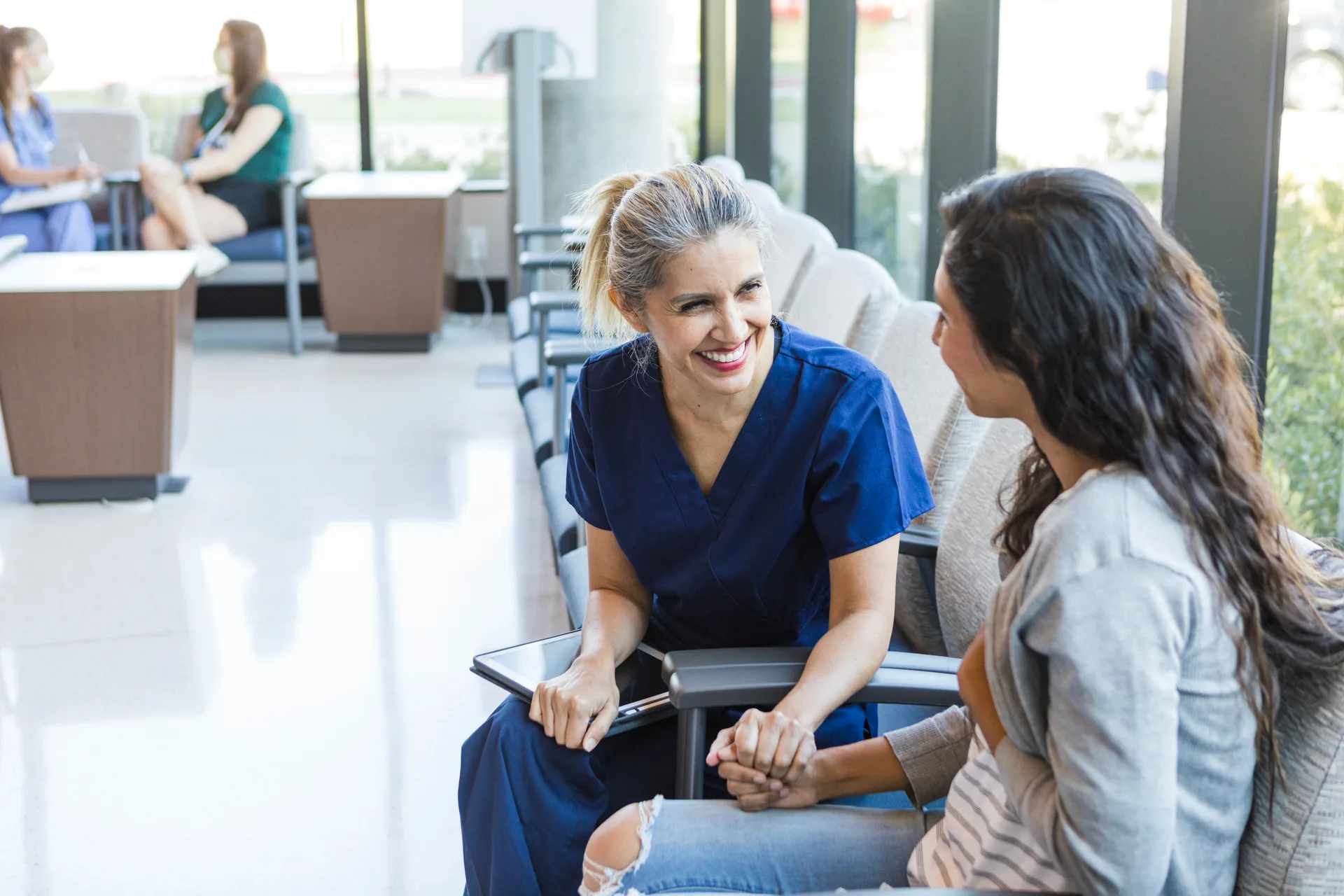 A cheerful doctor speaking with a patient in a waiting room