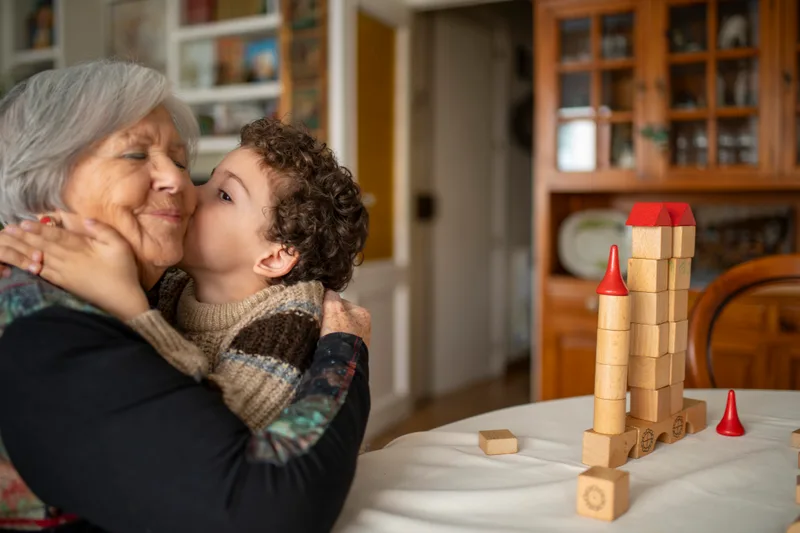 A grandson kissing his grandmother