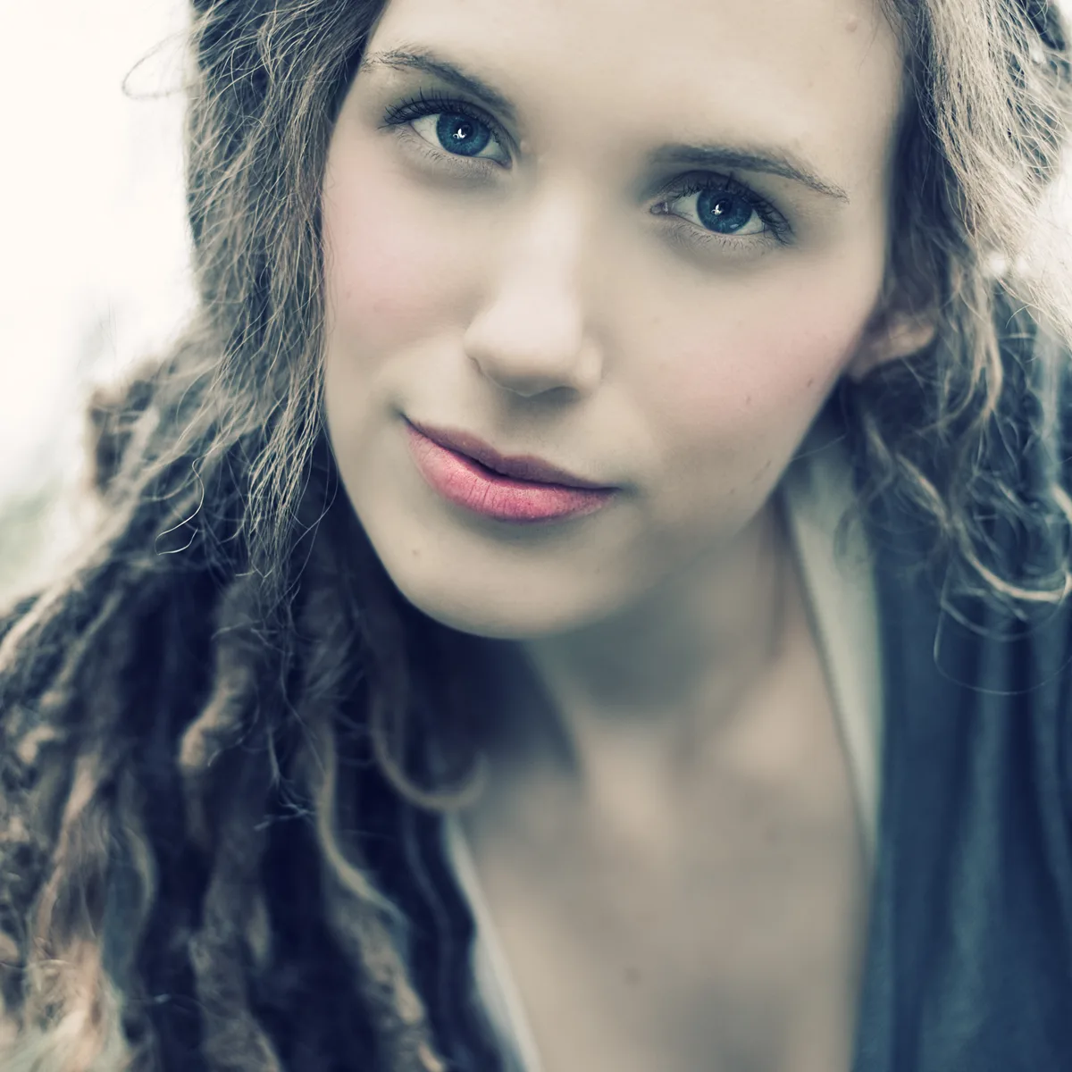 Close-up portrait of a woman with a soft, contemplative expression