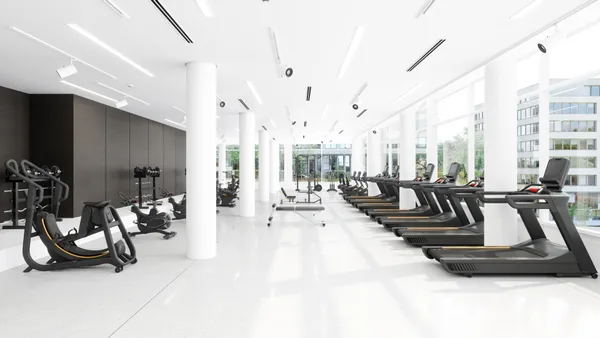 Member training under a coach in a modern gym