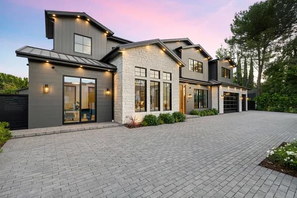 Modern home exterior listed for sale by a real estate team