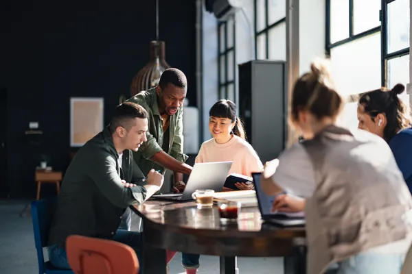 Software team collaborating around a product dashboard