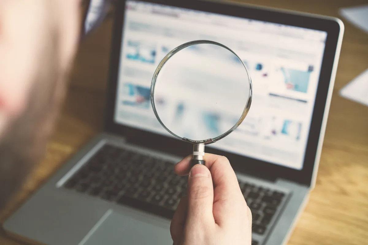Keyword research with magnifying glass and search terms