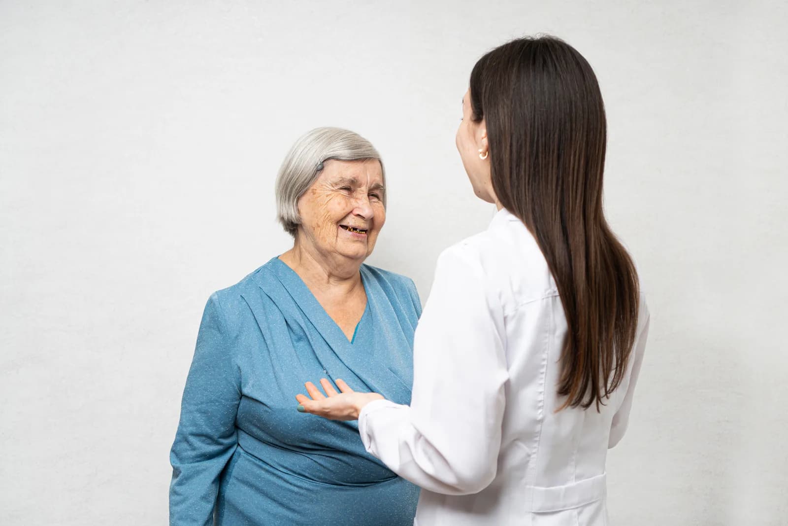 Caregiver sharing a warm moment with a senior resident at an assisted-living community
