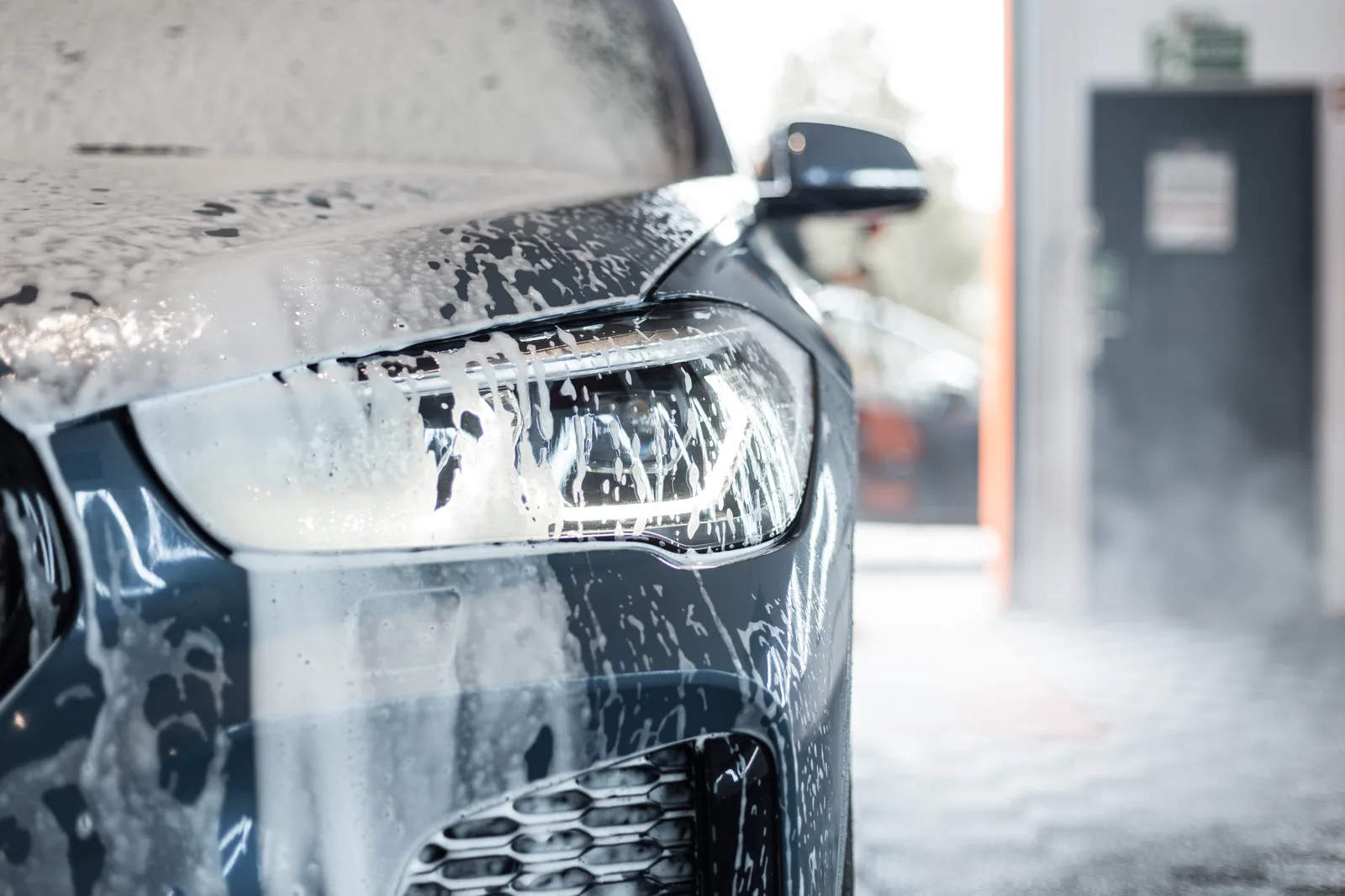 Car going through an automatic car wash with foam