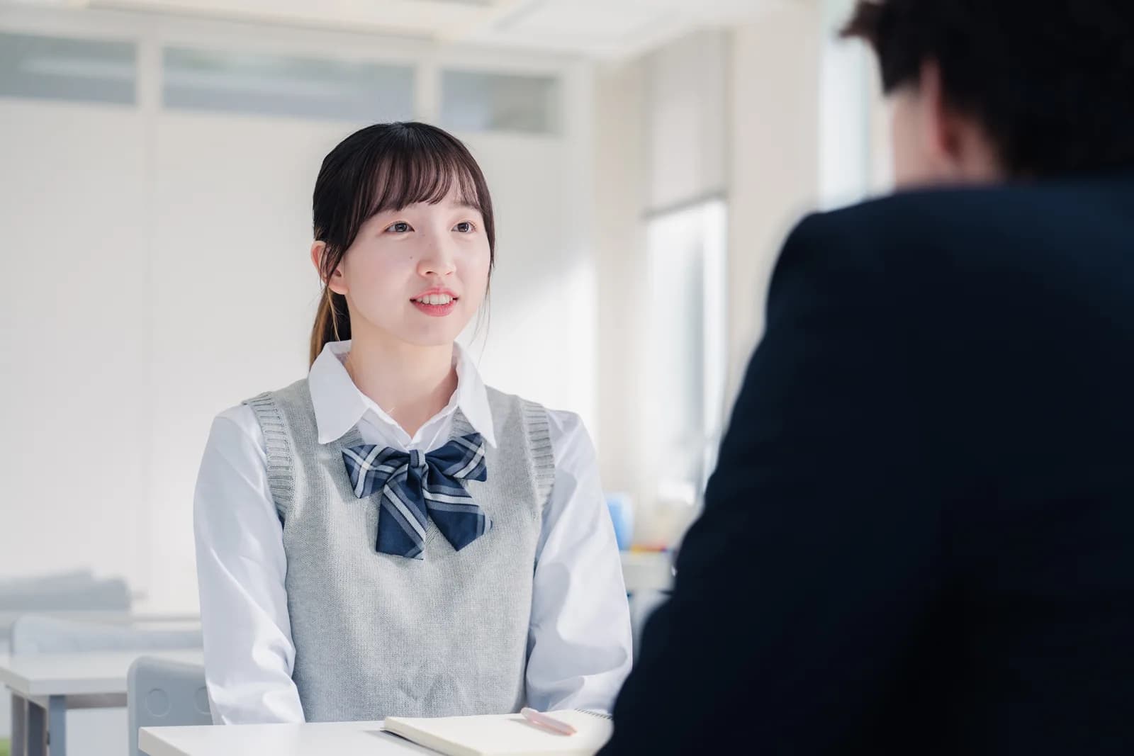 Counselor advising a high school student about college applications
