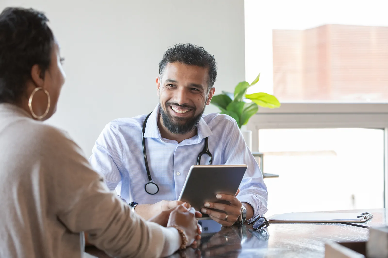 Plastic surgeon consulting with a patient during an appointment in a clinic
