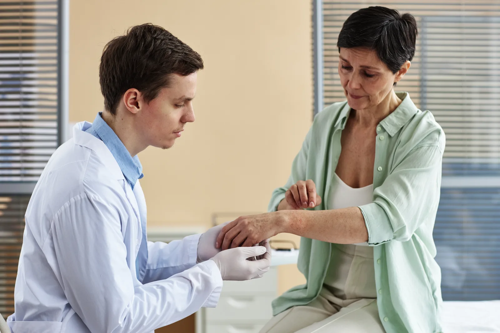 Dermatologist examining a patient's skin during a consultation in a clinic