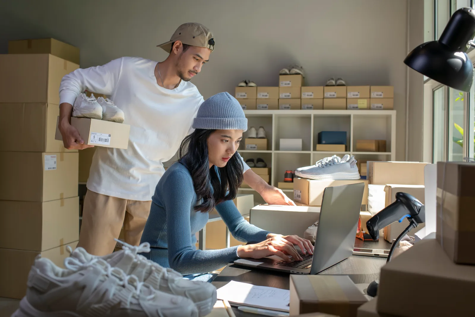 Online store owners preparing customer orders for shipping
