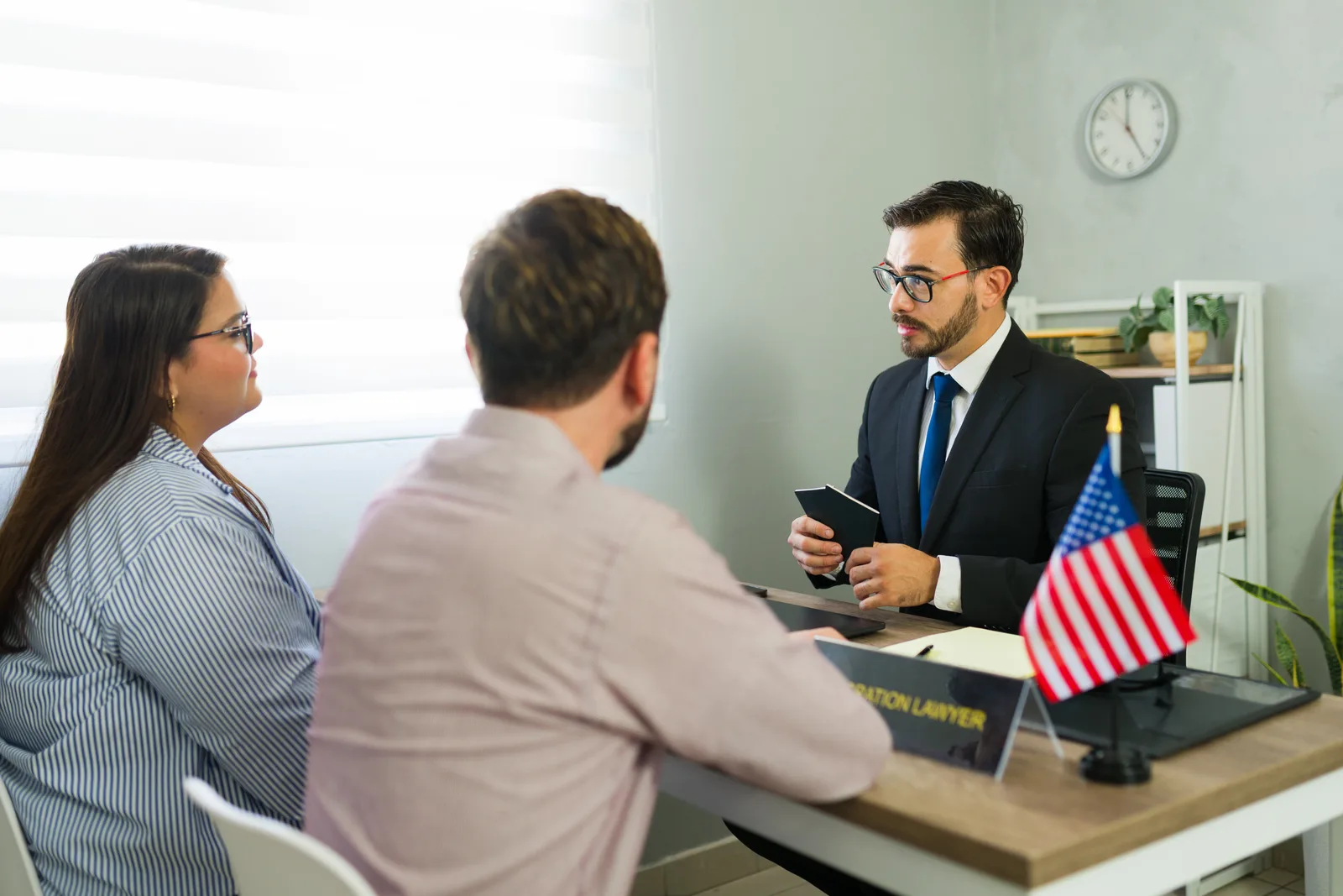 Immigration lawyer giving legal advice to a couple in an office