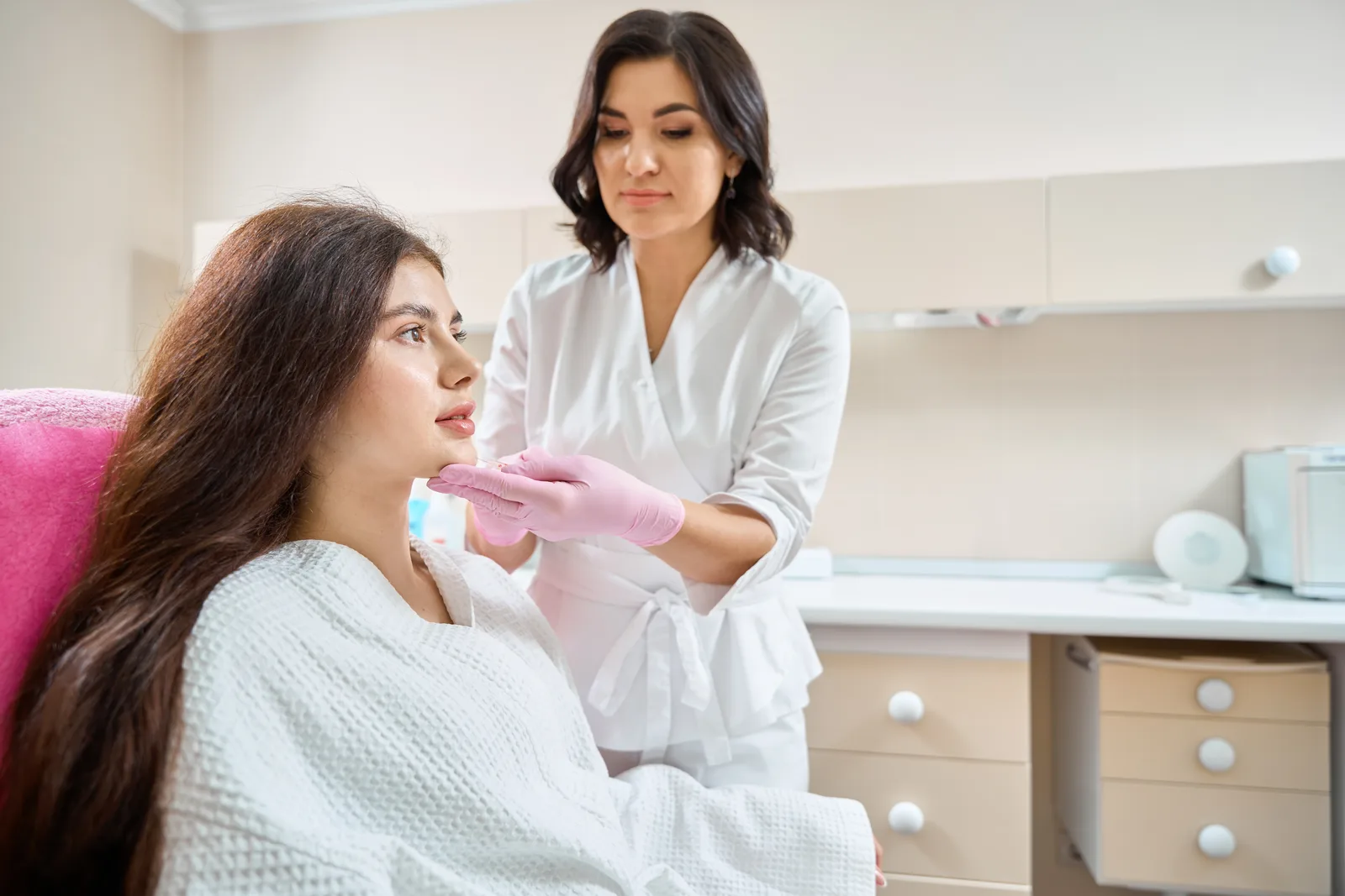 Aesthetic clinician performing a facial rejuvenation treatment on a client in a modern med spa