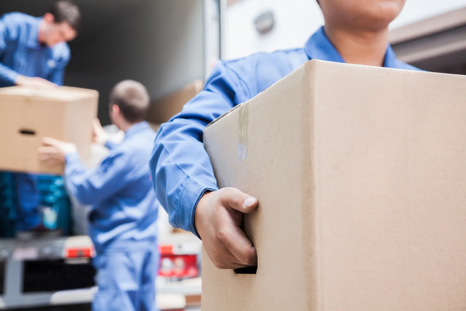 Movers unloading boxes from a moving van
