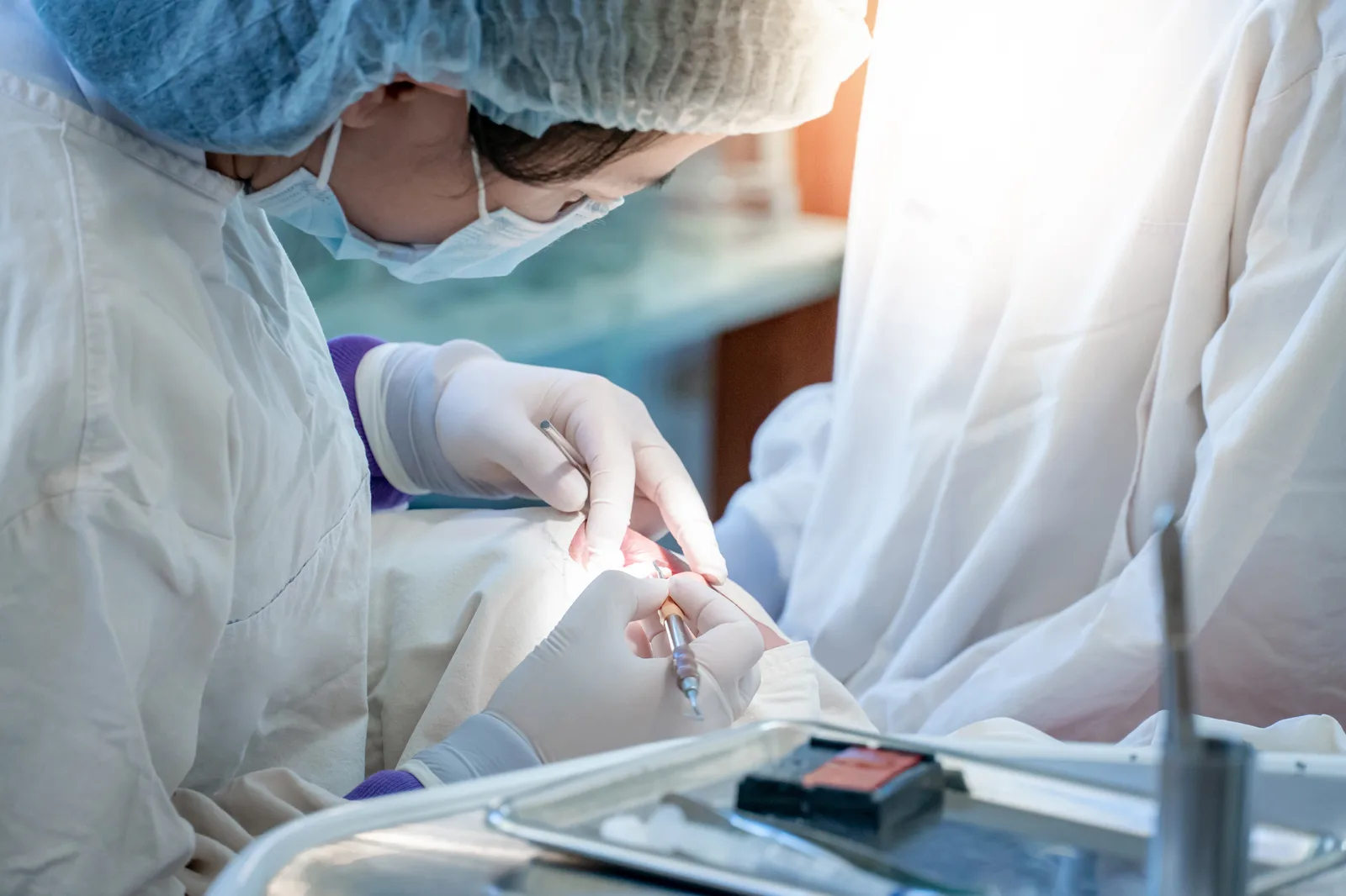 Oral surgeon treating a patient in a dental clinic