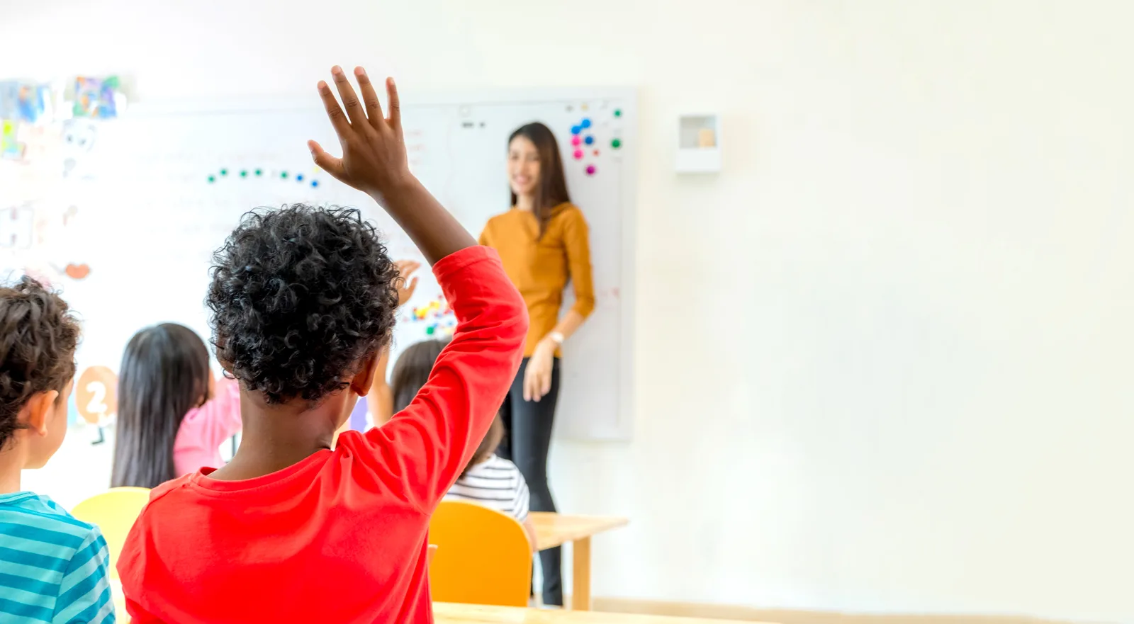 Teacher engaging students in a bright private school classroom