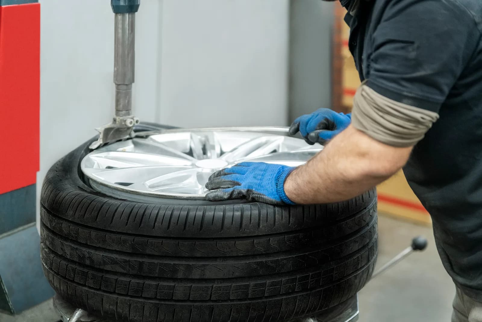 Mechanic installing a new tire on a car
