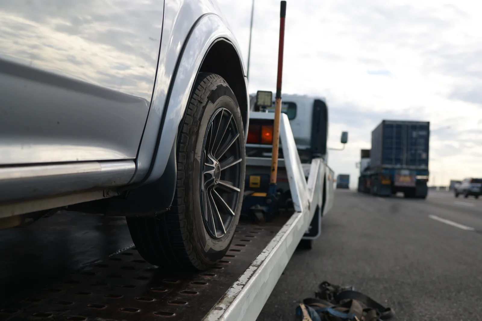 Tow truck loading a car on a street