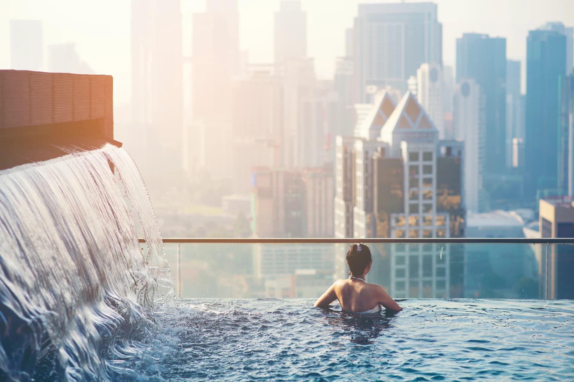 Rooftop pool with city skyline view at golden hour