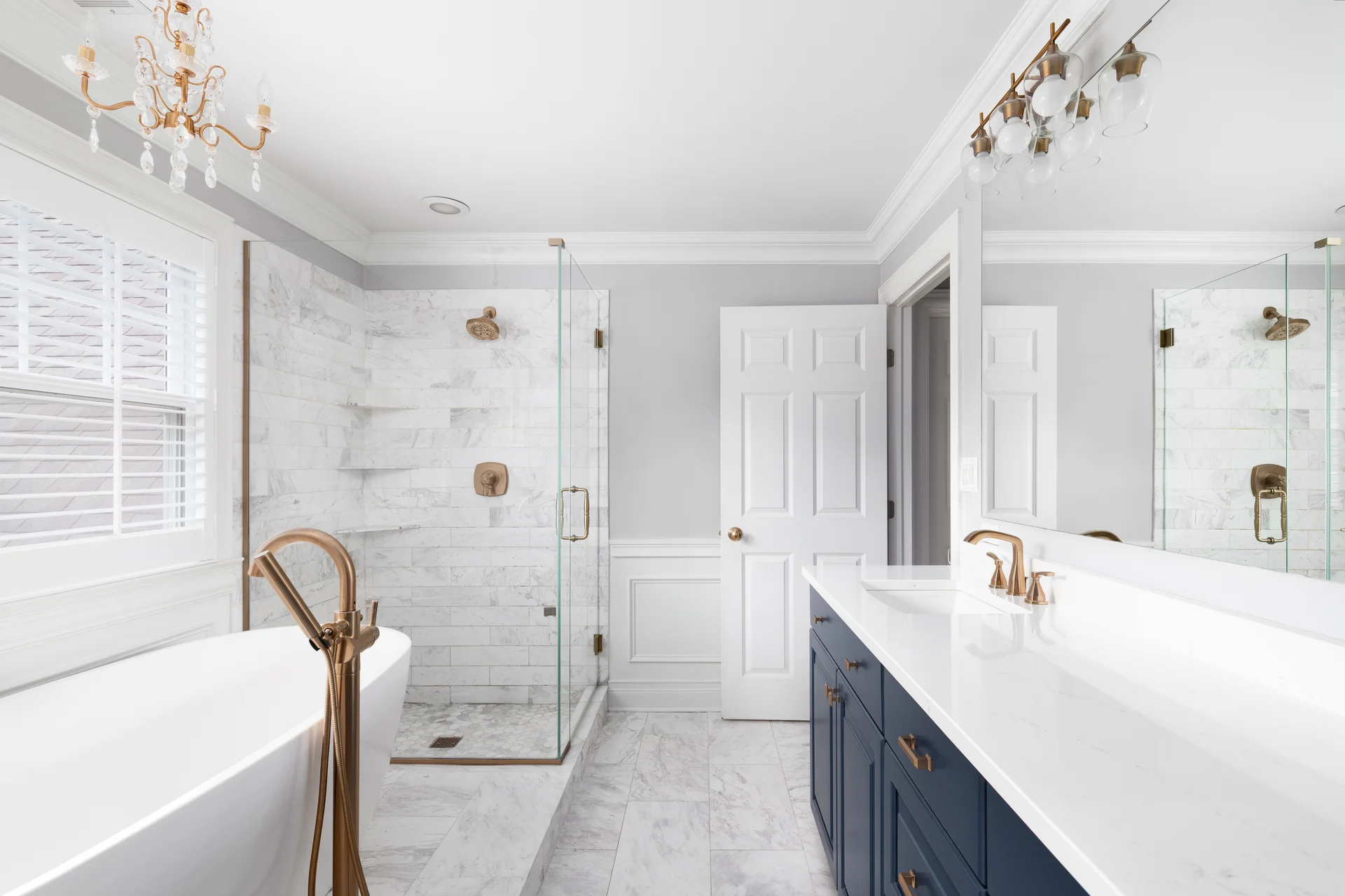 Modern bathroom with blue cabinet and tiled shower